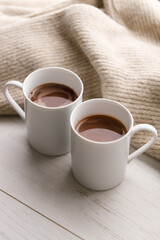 Cups of delicious hot chocolate and artisanal gift box