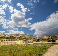 Roman ruins (against the background of a beautiful sky with clouds) in the Jordanian city of Jerash (Gerasa of Antiquity), capital and largest city of Jerash Governorate, Jordan