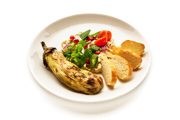 A plate of food with a vegetable and a salad