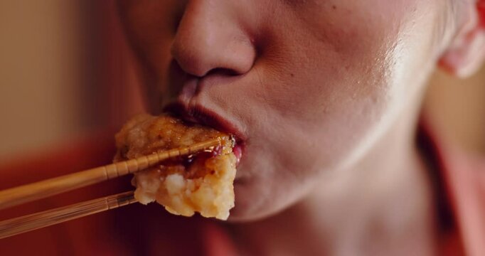 Woman, hands and eating food in Japan for traditional snack, cuisine and lunch break with chopstick. Female person, closeup and restaurant for dinner, indigenous meal and nutrition with rice cracker