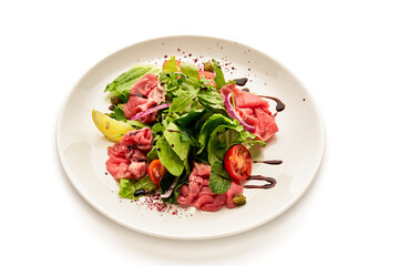 A plate of food with a variety of vegetables and meat