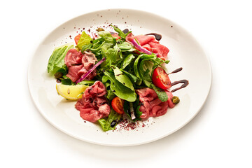 A plate of food with a salad on it