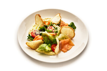 A plate of food with a variety of ingredients including lettuce, tomatoes