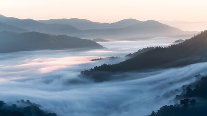 Fototapeta premium A serene mountain range covered in thick, swirling mist, with layered peaks fading into the distance.