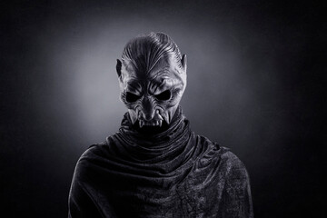 Vampire showing his scary teeth over dark misty background