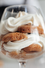 Tiramisu cake in glass jars. Traditional italian layered dessert in glasses. Closeup view. stock photo