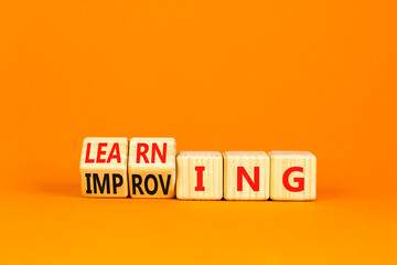 Doing or learning symbol. Turned wooden cubes and changed the word Doing to Learning . Beautiful orange table orange background. Educational business doing or learning concept. Copy space.