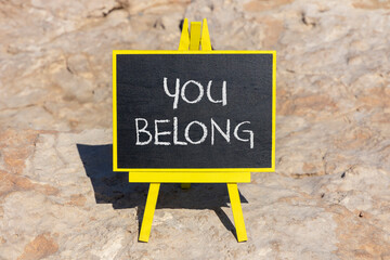 Belonging and you belong symbol. Concept words You belong on beautiful yellow chalk blackboard....