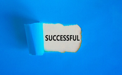 Successful symbol. Concept word Successful on beautiful white paper. Beautiful blue paper background. Business successful concept. Copy space.