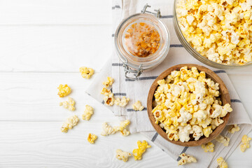Salty popcorn on bright color background. Cinema and entertainment concept. Movie night with popcorn. Delicious appetizer, snack.Space for text, copy space. Banner