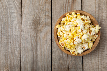 Salty popcorn on bright color background. Cinema and entertainment concept. Movie night with popcorn. Delicious appetizer, snack.Space for text, copy space. Banner