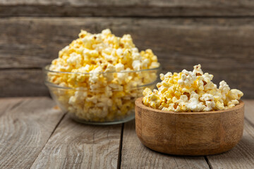 Salty popcorn on bright color background. Cinema and entertainment concept. Movie night with popcorn. Delicious appetizer, snack.Space for text, copy space. Banner