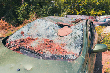 Damaged civilian car after missile strike (close-up with view of windshield). War in Ukraine