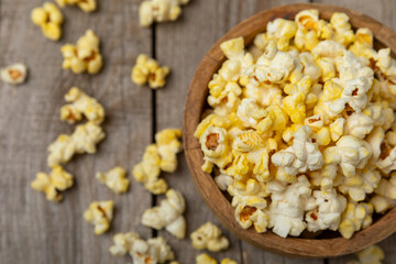 Salty popcorn on bright color background. Cinema and entertainment concept. Movie night with popcorn. Delicious appetizer, snack.Space for text, copy space. Banner