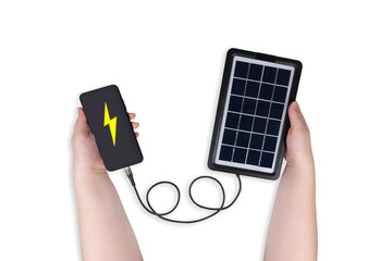 Portable solar panel in one hand connected to smartphone in other hand on white background (close-up). On the smartphone screen is a lightning icon. Renewable green alternative energy concept