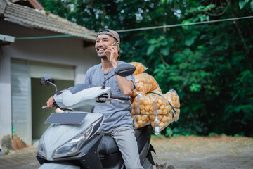 A cheerful delivery person riding a scooter, happily chatting while transporting fresh goods