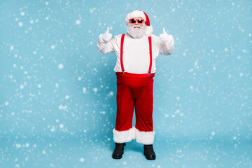 Full body photo of funny funky fat santa claus with big belly abdomen in eyewear show thumb up...
