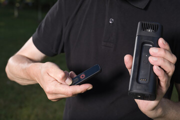 Older man uses two types of smoke machine generators on outdoor location