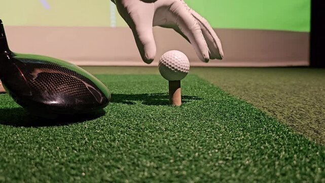 Golf driving practice session at indoor facility with simulator and ball - Powered by Adobe