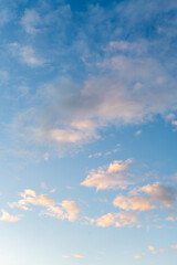 Blue sky and floating fluffy clouds with sunlight reflection