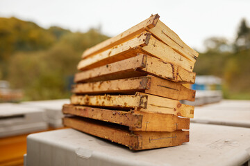 Stack of wooden frames with honeycombs.
