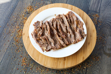 Portion Doner kebab meat served in plate isolated on wooden board top view of arabic and turkish fast food