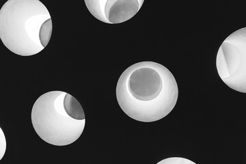 Dark ceiling with bright round windows in it, abstract photo