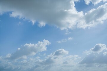 Bright sky filled with fluffy white clouds on a clear day