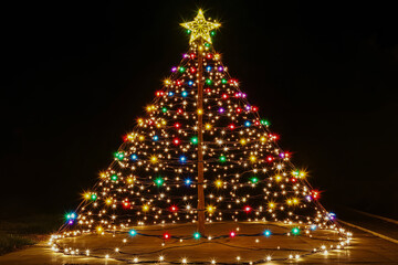 A Christmas tree entirely made of twinkling string lights, arranged in a conical shape to resemble a traditional tree.
