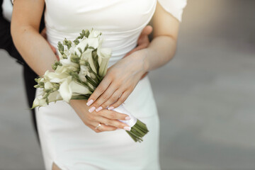 stylish wedding bouquet of fresh flowers in the hands of the bride
