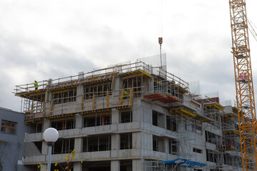 The project includes building a large structure with scaffolding and a crane visible in the background