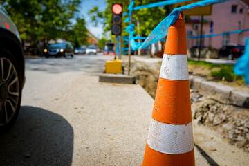 Traffic cone tied, connected, with blue warning tape