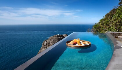 Obraz premium Infinity pool on the edge of a cliff, blending with the ocean, with a floating breakfast