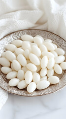 A Bowl of Oval-Shaped White Candies on a Marble Surface