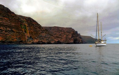 Saint Helena Sailboat Against Stunning Coastal Terrain, Atlantic Ocean showcasing the island’s...