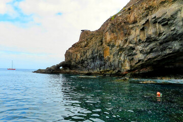 Saint Helena’s coastline with clear turquoise waters and rugged rock formations. A peaceful view...