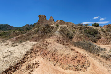 Eroded rock and mud formations in the Los Monegros desert, Huesca under an intense blue sky
