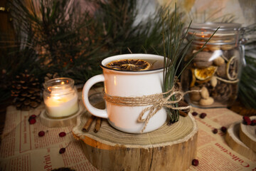 Cozy decorated tea mug with pine branches on a Christmas atmosphere background