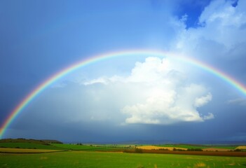 Naklejka premium Rainbow with Holographic Clouds Rainbow arching over a landscape