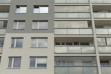 The facade of a sleek, modern apartment building beautifully showcasing numerous balconies and...