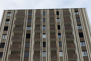 The facade view of a residential building showcases multiple balconies, enhancing its overall appeal