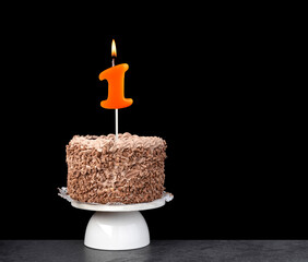 Birthday card with candle number 1 - Chocolate cake on black background.