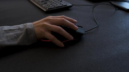 Gamer's hand clicking a mouse in slow motion highlights precision and focus in a competitive gaming environment