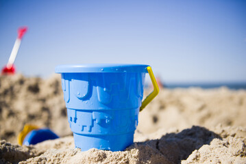 Blue toy bucket on the beach