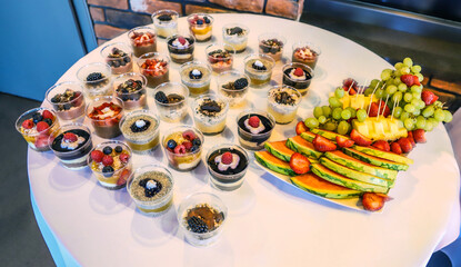 Dessert buffet or candy bar during catering event, fruits and whipped cream