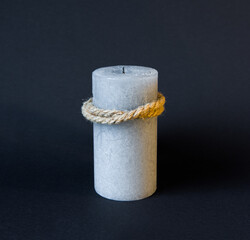 gray candle on black background