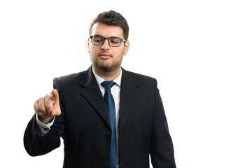 Serious male entrepreneur touching invisible screen copyspace