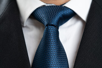 Close-up of blue tie as casual male business clothing concept