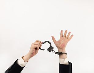 Businessman's hands in steel handcuffs