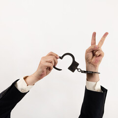 Businessman's hands in steel handcuffs